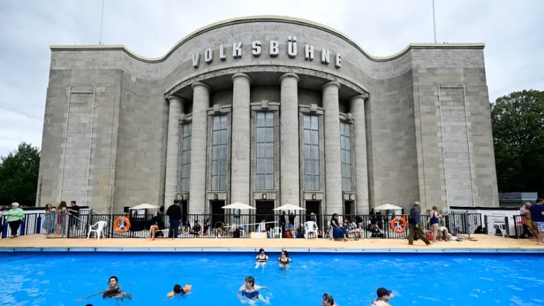 Des-visiteurs-se-baignent-dans-la-piscine-dite-Volksbad-installee-devant-le-theatre-Volksbuehne-sur-la-place-Rosa-Luxemburg-Platz-a-Berlin-le-7-aout-2026-jour-de-son-inauguration-2332367